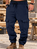Navy multi-pocket cargo joggers in illustrative worksite setting